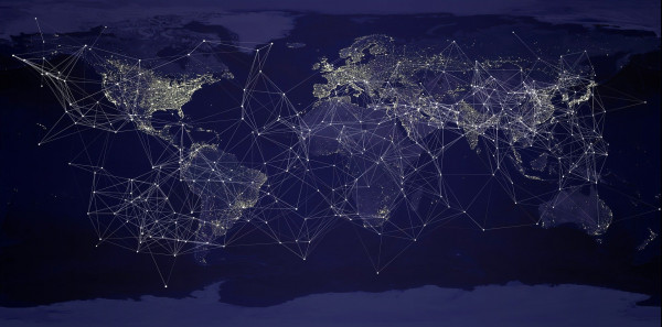 Artistic representation of a network across a night-view world map
